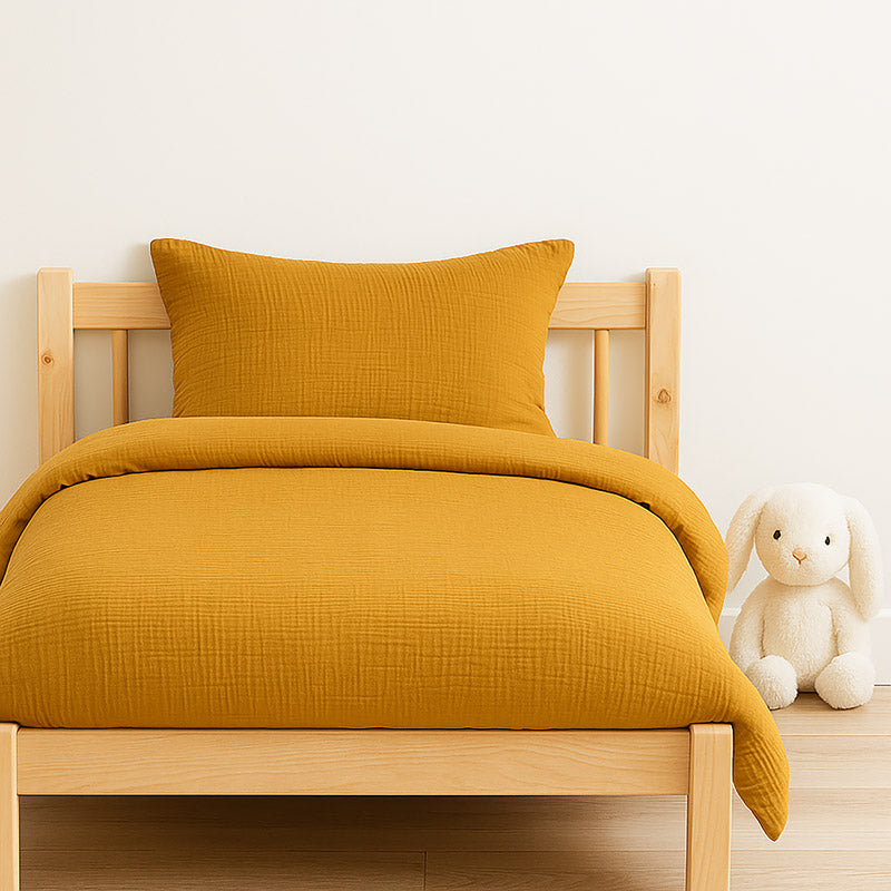 Housse de couette pour lit d'enfant en coton biologique de couleur honey, pliée de manière élégante. coton bihoney papate